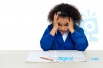 stressed-out-primary-girl-child-holding-her-head-100155111